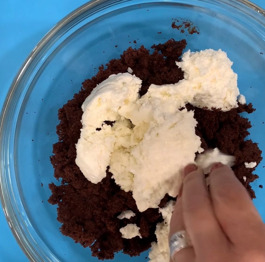 Mix buttercream icing with cake crumbs.